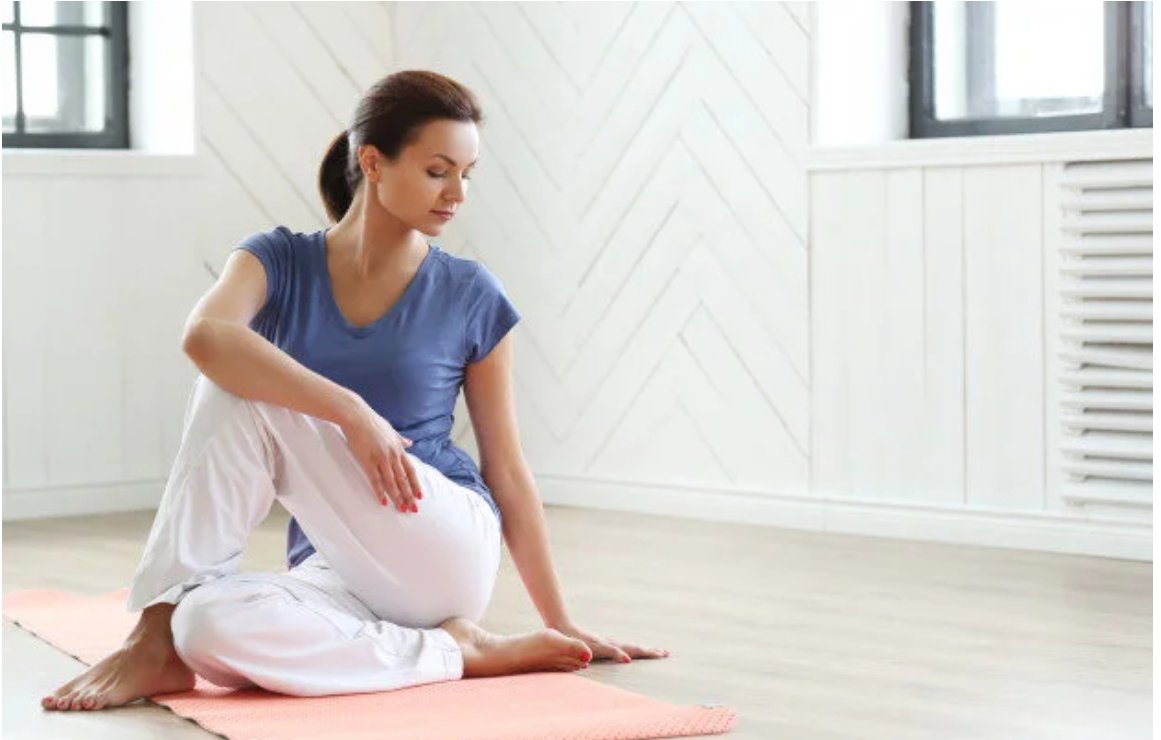 Client doing seated mobility work on a mat